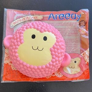 Areedy pink monkey cake squishy toy